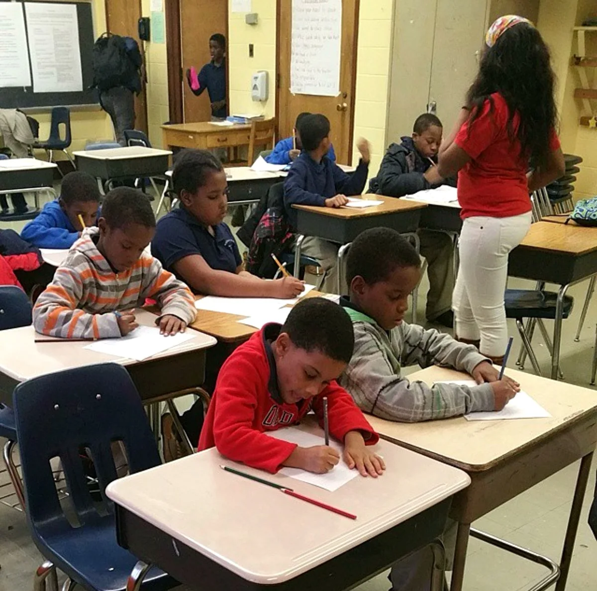 Students writing at their desks during a C4D Kidz class